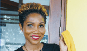 Sachkia Barnes smiling and holding a yellow jacket